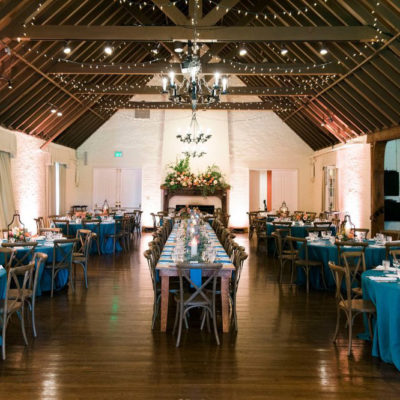 Long row of farm tables in ballroom