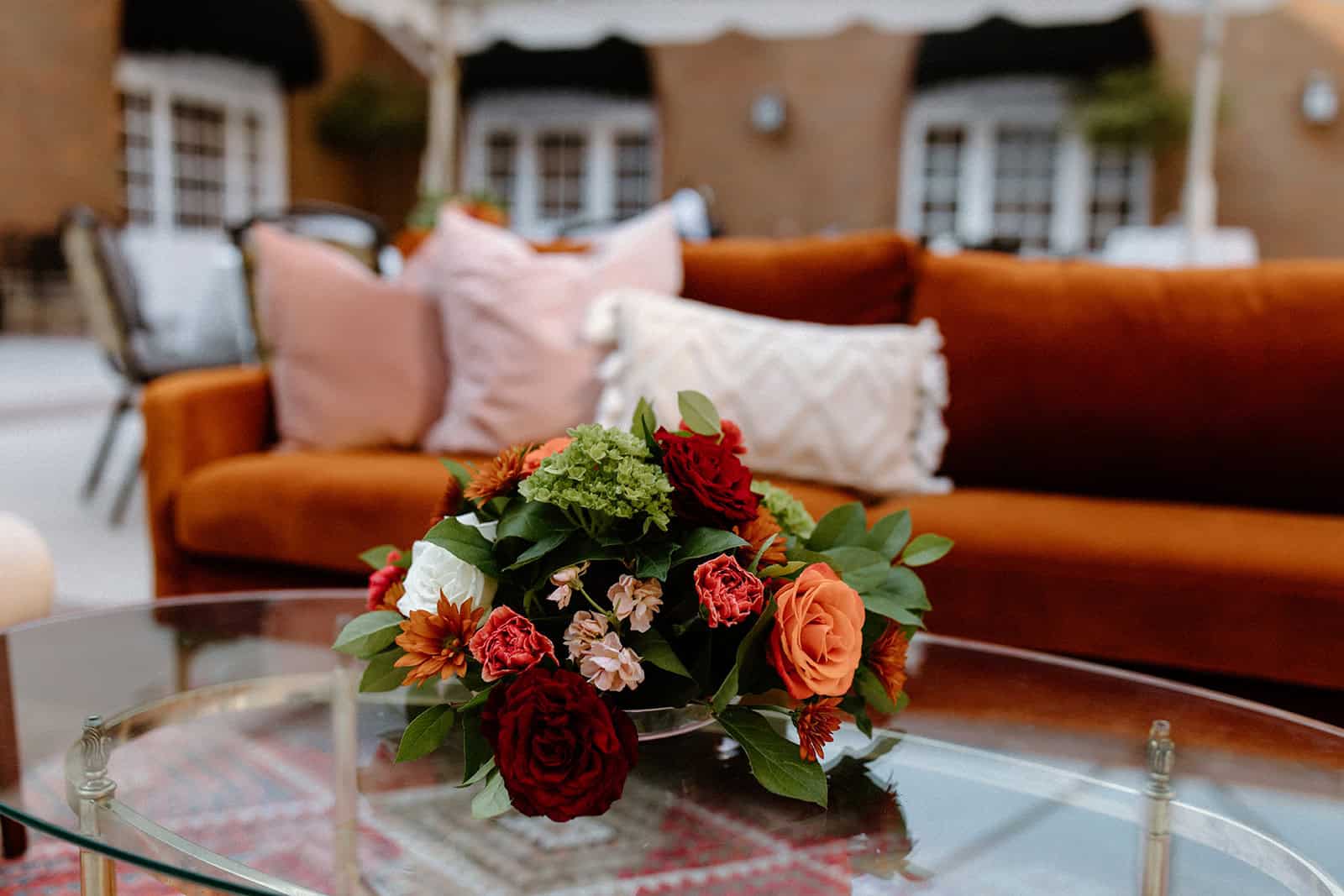 Rust sofa with a coffee table and flowers